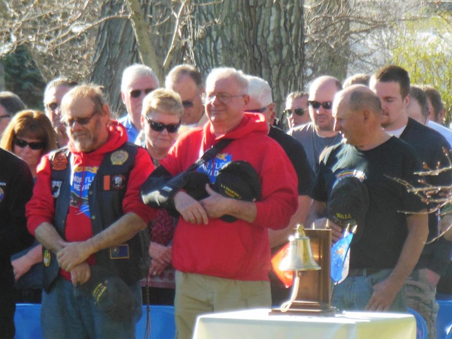 Veterans listen to the invocation Saturday at Mills Park.