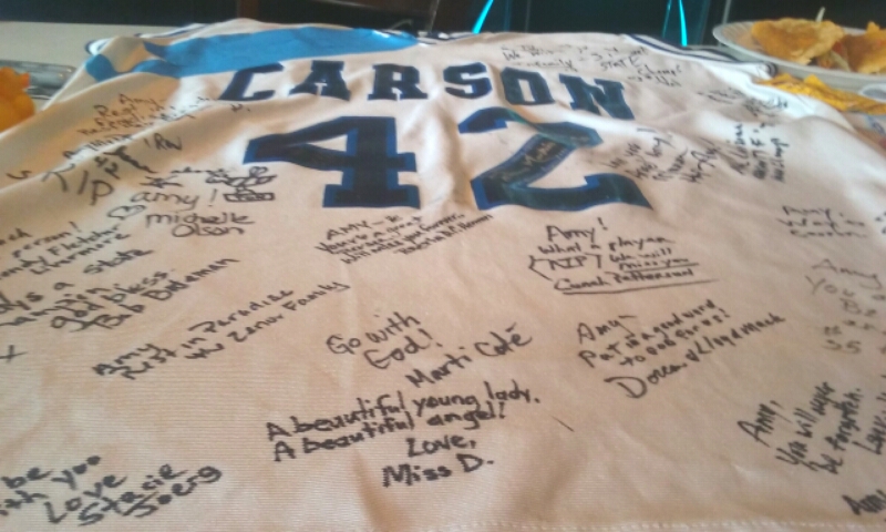 Photos by Brett Fisher. A Carson High No. 42 basketball jersey covered in signatures.