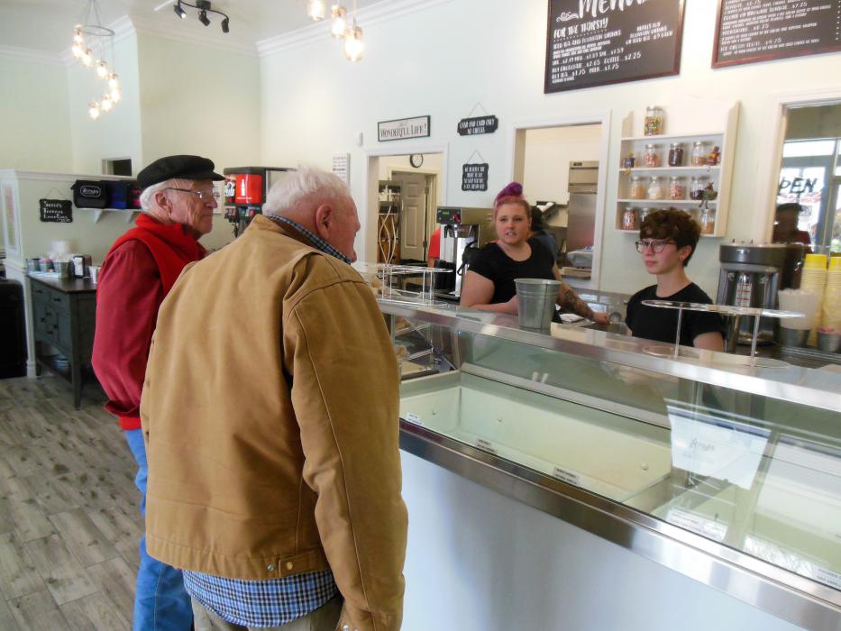 Patrons order ice cream at the counter Tuesday at Scoup's.