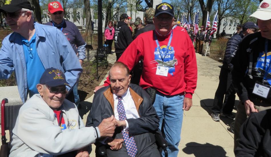Don Quilici, in the red shirt, has his picture taken with Sen. Bob Dole.