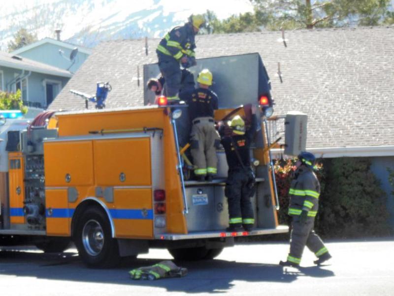 Photos by Brett Fisher. Firefighters clean up after knocking down an apartment fire Saturday.