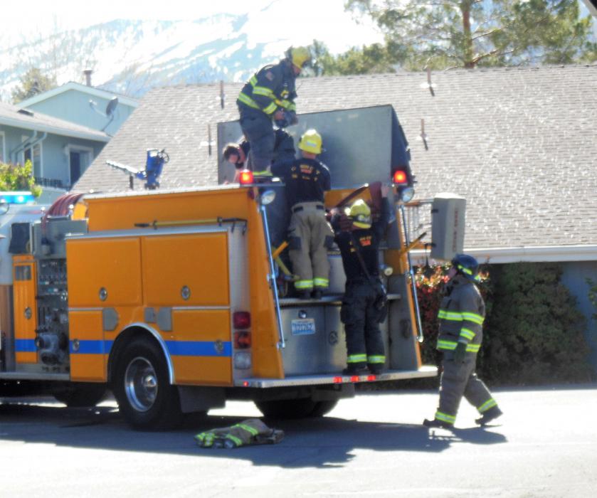 Photos by Brett Fisher. Firefighters clean up after knocking down an apartment fire Saturday.