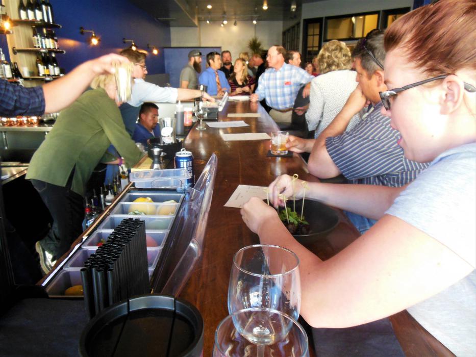 A server puts the finishing touches on an appetizer at the bar Monday.