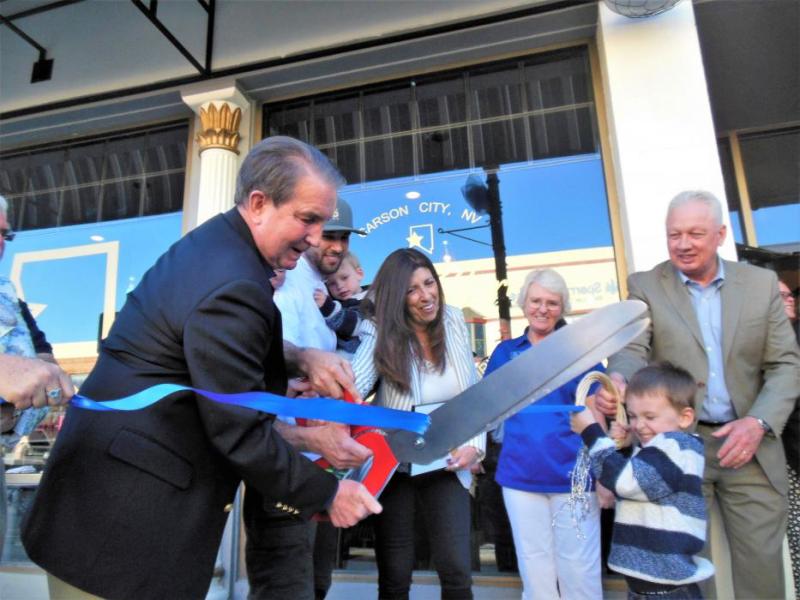 Photos by Brett Fisher. Carson City Mayor Bob Crowell cuts the ribbon with the Stern family Monday at Battle Born Social.
