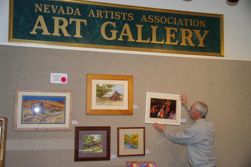 NAA member Mark Kyle hanging new art.