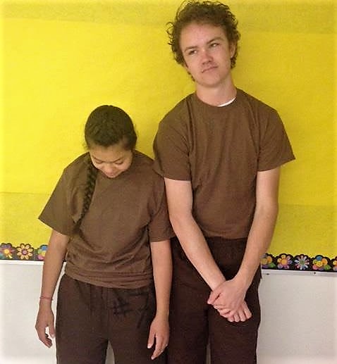 Students model the disciplinary brown outfits worn by those who violate the dress code.