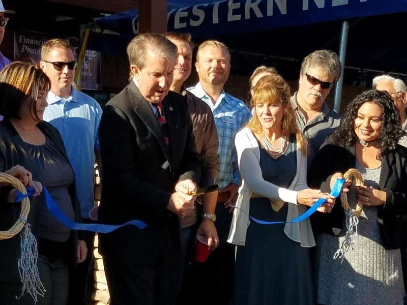 Photos by Brett Fisher. Mayor Bob Crowell cuts the ribbon Thursday at Battle Born Business Center.
