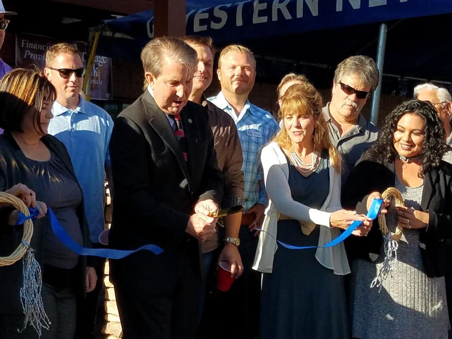 Photos by Brett Fisher. Mayor Bob Crowell cuts the ribbon Thursday at Battle Born Business Center.
