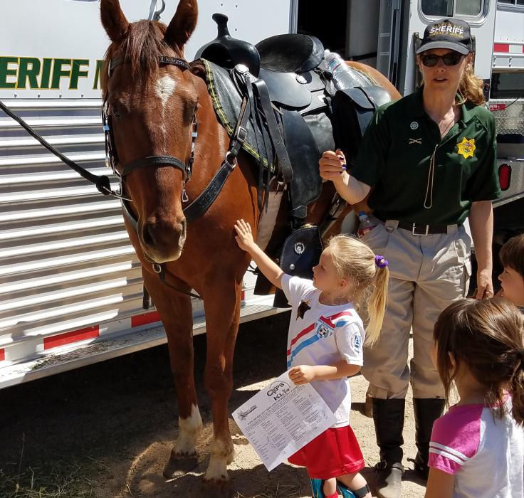 An equine officer greets children Saturday at the CCSO on E. Musser St.