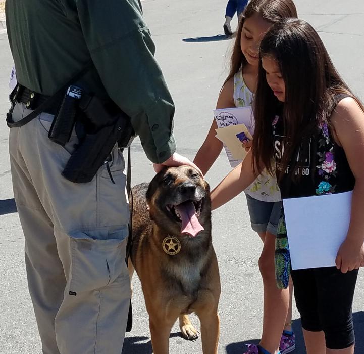 A K9 officer greets children at the Cops and Kids Open House Saturday.