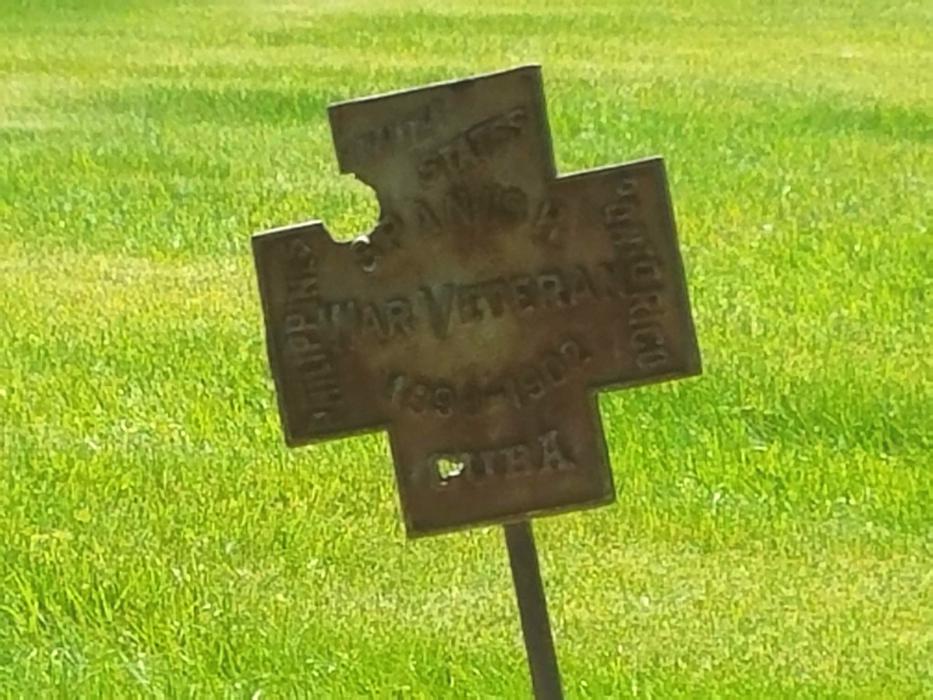 A military service cross marking a veteran's grave at Lone Mountain Cemetery.