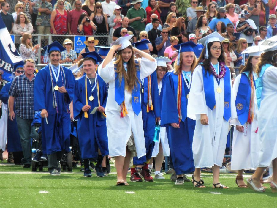 CHS seniors file onto the football field to take their seats Saturday morning.