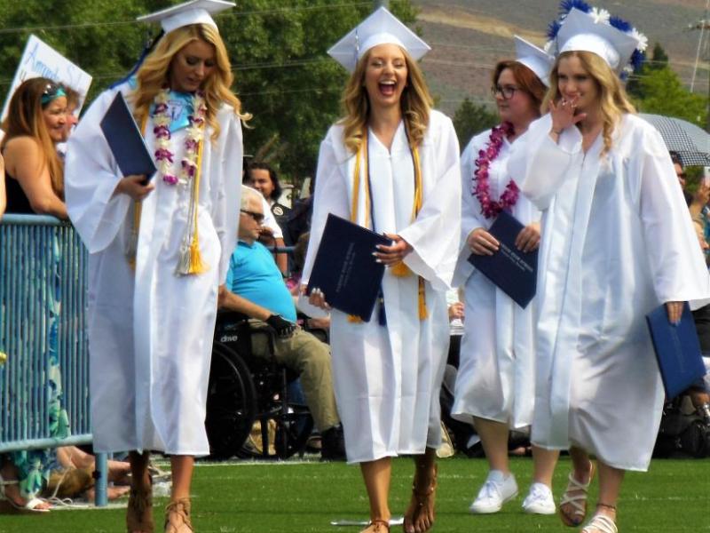 Photos by Brett Fisher. Excited CHS seniors walk back to their seats after receiving their diplomas.
