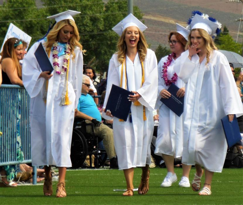 Photos by Brett Fisher. Excited CHS seniors walk back to their seats after receiving their diplomas.
