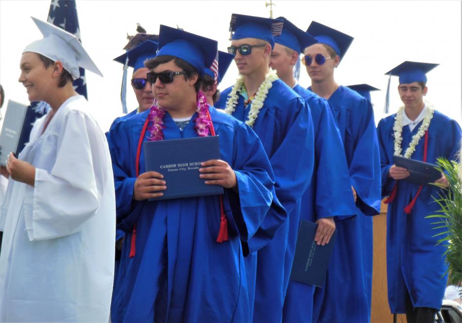 Line of seniors wait to exit the stage upon receiving their diplomas Saturday.