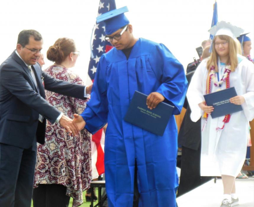 CHS senior shakes hands Saturday upon receiving his diploma.