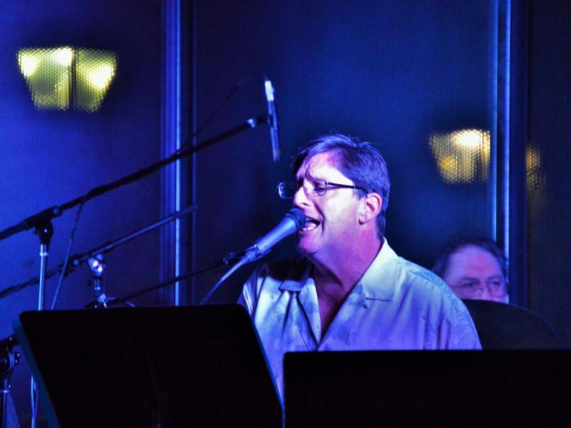 Photos by Brett Fisher. Vocalist-pianist performs on stage at McFadden Plaza in 2016.