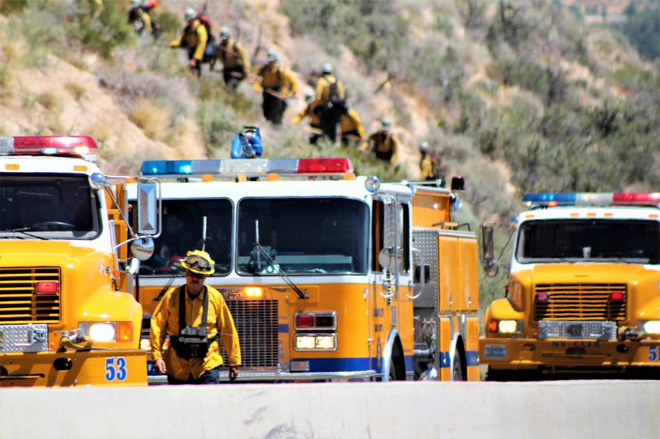 Fire engines lined Highway 50 westbound while firefighters created a line around the fire. Photo by Brett Fisher