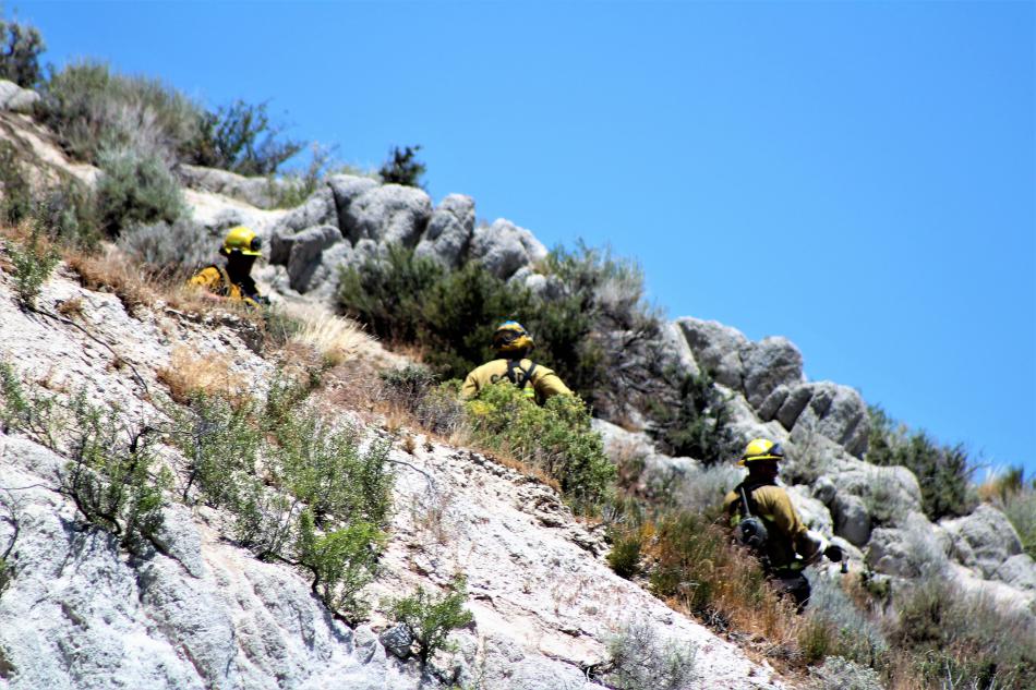 Firefighters take aim at a ridge above Highway 50 Spooner. Photo by Brett Fisher