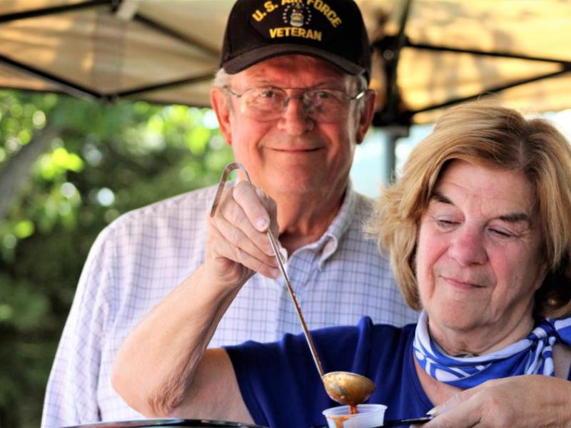 Photos by Brett Fisher. A U.S. Air Force veteran and his wife from Reno serve up chili to guests Saturday at Glen Eagles.