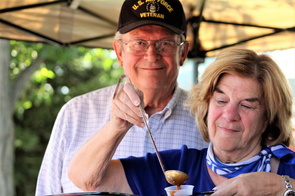 Photos by Brett Fisher. A U.S. Air Force veteran and his wife from Reno serve up chili to guests Saturday at Glen Eagles.