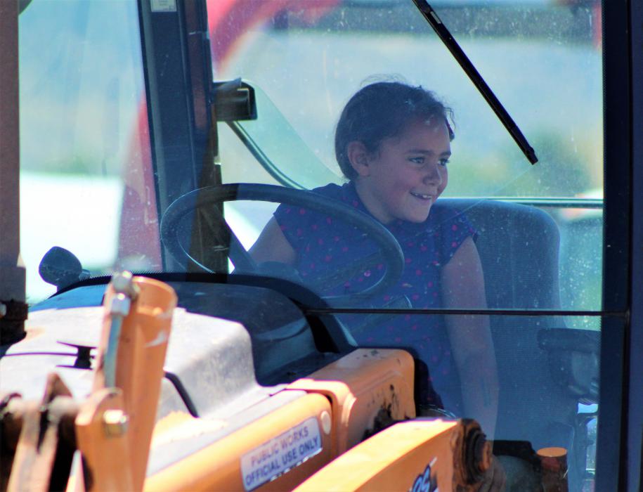 A girl sits in the cab of a bulldozer Saturday at the Carson City corporate yard.