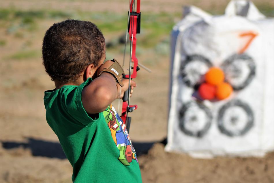 Photos by Brett Fisher. Skylar Easley, 7, of Reno shoots at a balloon target using a compound bow.