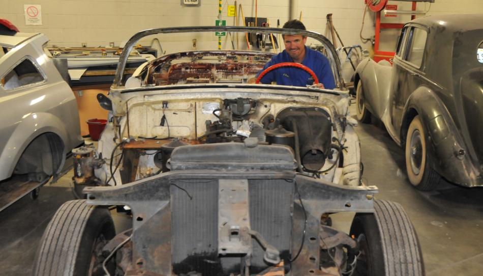 WNC instructor Jason Spohr sits behind the wheel of a 1953 Cadillac convertible.