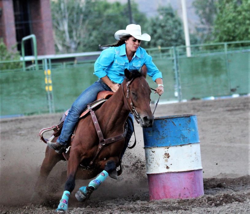 A barrel racer makes her cut around a barrel Friday.