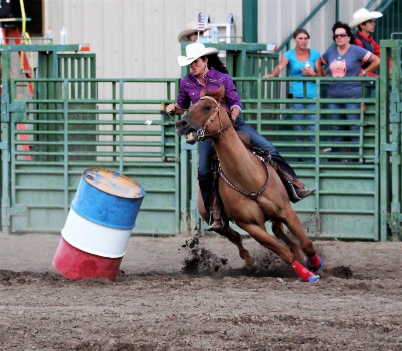 A barrel sways after being brushed by the horse in Friday's barrel race.