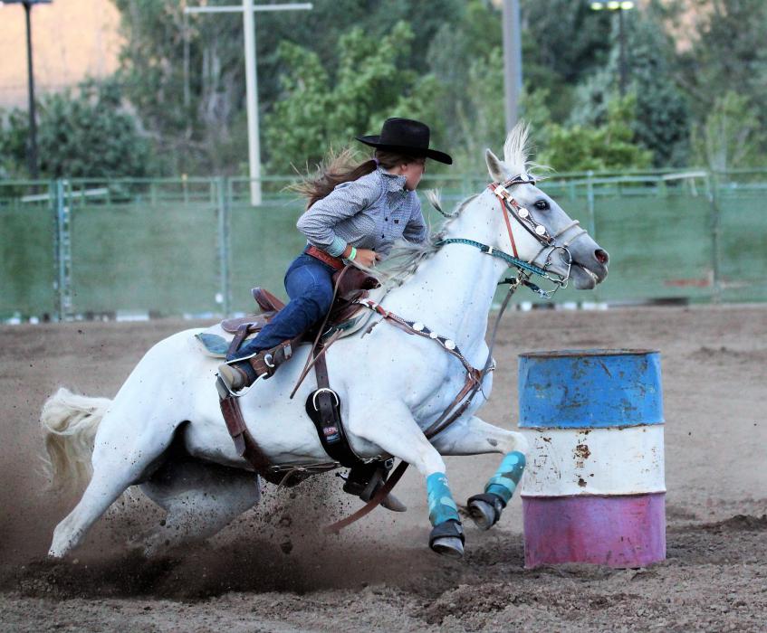A barrel racer sprints toward the next barrel in Friday's timed race.