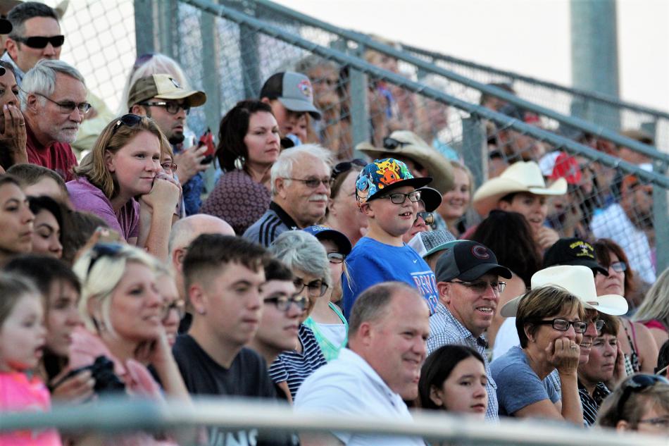The crowd in the arena stands watch barrel racers Friday evening.