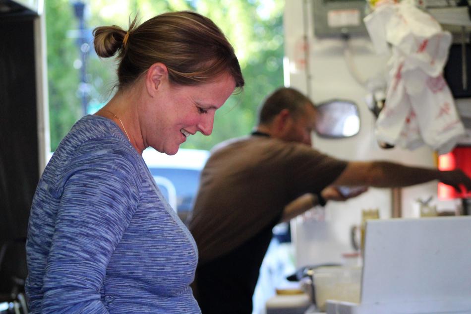 Cherrie Palacios works The Lazy Hog's counter as Fernando Palacios cooks.