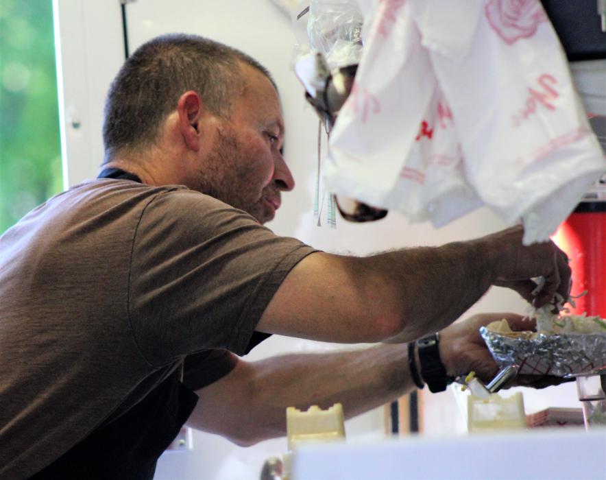 Fernando Palacios puts the finishing touches on an order of tacos.