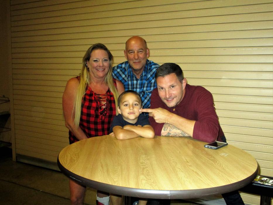 Photo by Isaiah Burrows. Country music star Ty Herndon (right) with a young fan at Battle Born Harley Davidson Saturday.