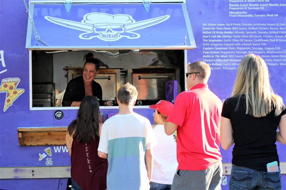 Desiree Kagan smiles at customers while taking food orders Wednesday at the BAC.