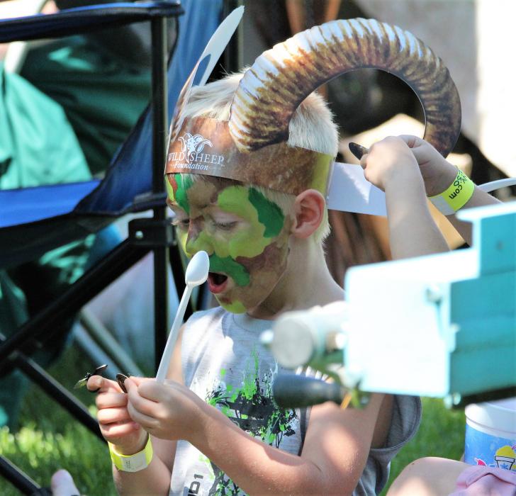 A boy is amazed by a magic performed by a member of the Pirates of Reno Saturday in Mills Park.