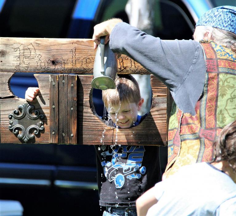 A boy is anointed with water in a buccaneer ritual by Captain Krakken of the Pirates of Reno.