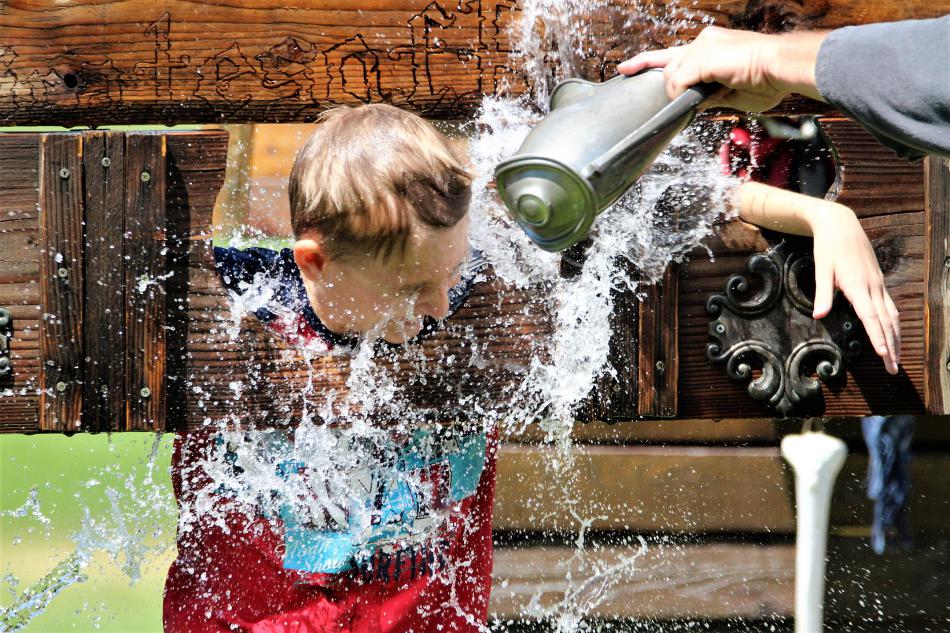Photos by Brett Fisher. A youth receives a refreshing splash of cool water in a ritual performed by the Pirates of Reno.