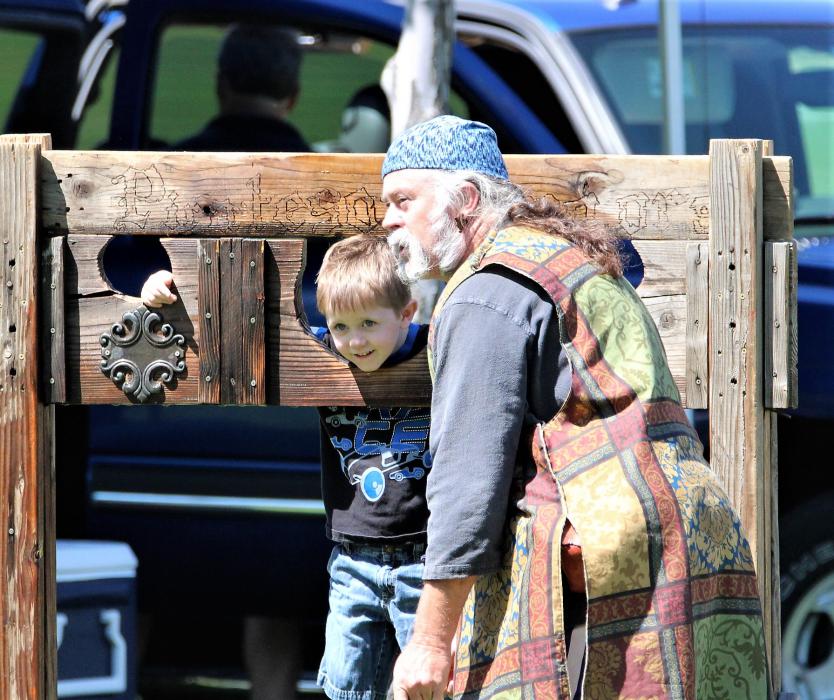 Captain Krakken with the Pirates of Reno talks to a boy in the stocks Saturday.