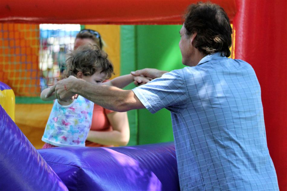 Father and daughter on a bounce slide Saturday in Mills Park.