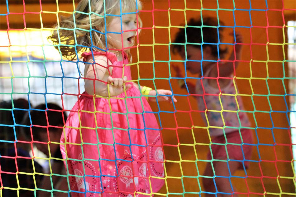 Children jump up and down in a bounce house at Mills Park Saturday.