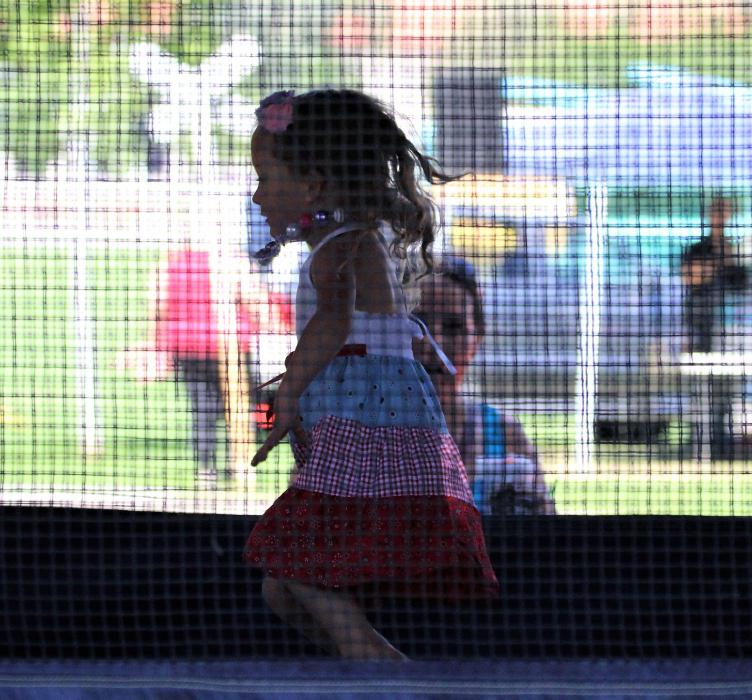 A little girl in a bounce house Saturday in Mills Park.