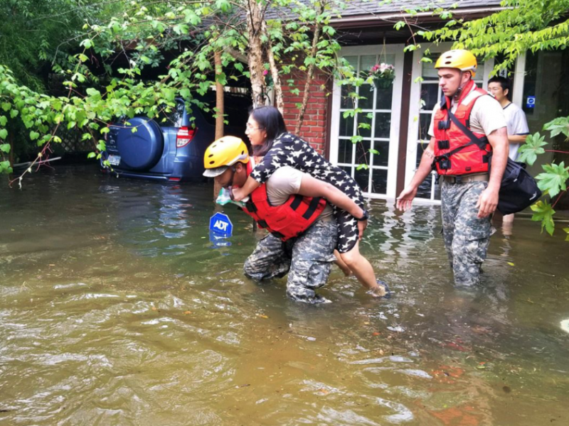 A Texas National Guardsman carries a resident from her home. Army National Guard photo by Lt. Zachary West