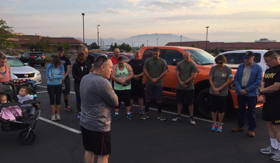 Runners and walkers take in a prayer before the memorial event.