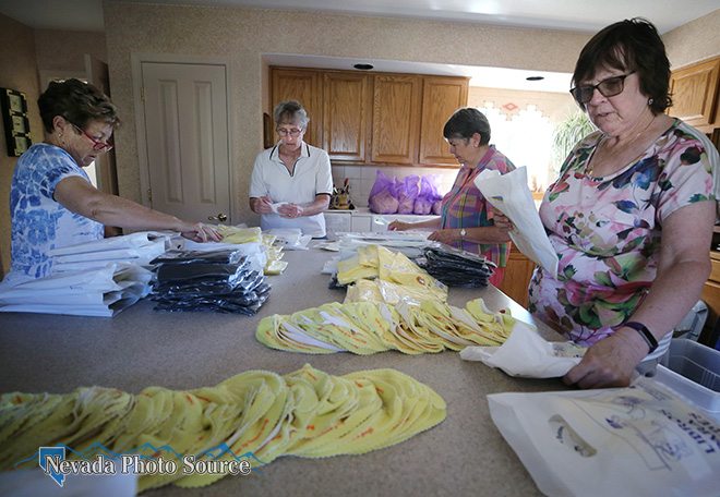 Friends of the Carson City Library volunteers prepare Books For Babies packets. Cathleen Allison, Nevada Photo Source