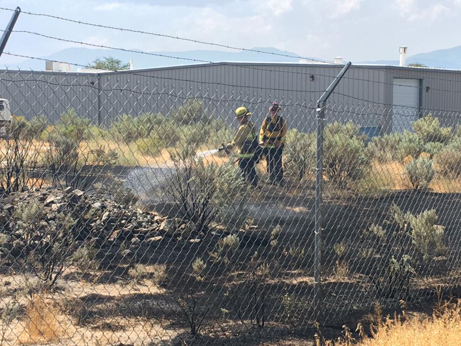 Firefighters extinguishing flames at lot off Arrowhead Drive. Photo by Kirk Caraway