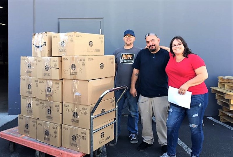 Photos courtesy NNDC. Volunteers stand next to a pallet of boxed up rescue bags ready for shipment to Houston.
