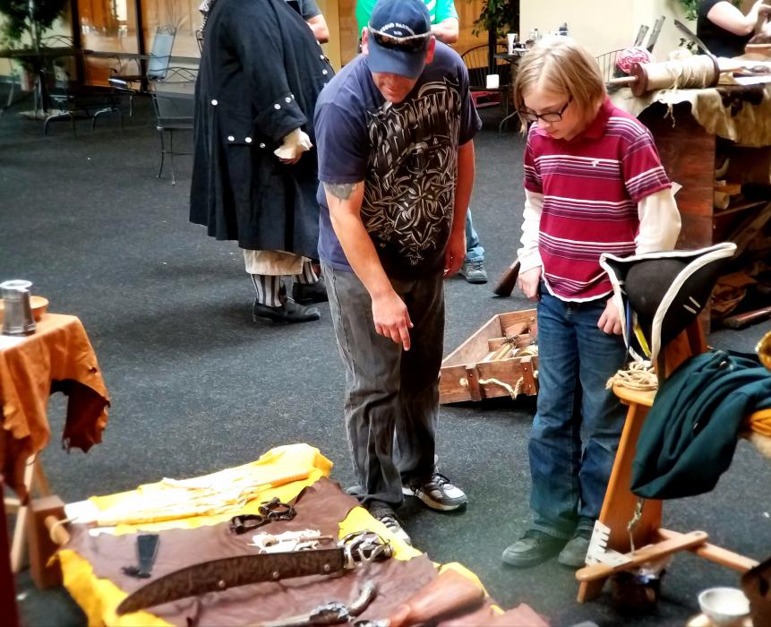 Visitors inspect weaponry from the pirate era.
