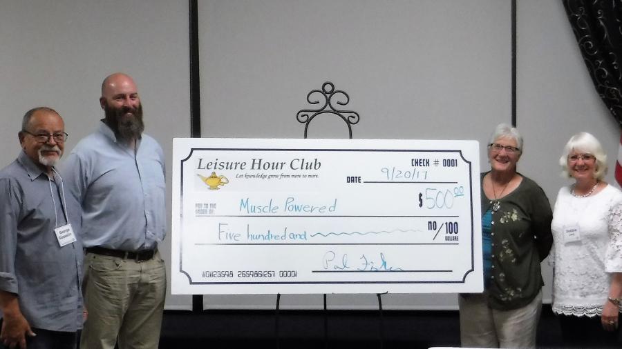 Leisure Hour Club President Debbie Lane presents $500 donation to Randy Gaa, Secretary of Muscle Powered.